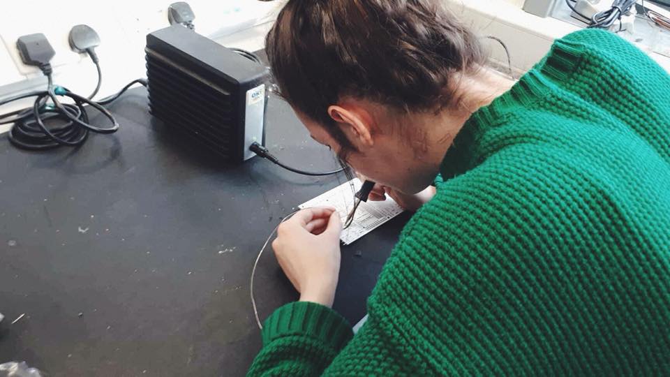 Team Member leaning over Speeduino while soldering